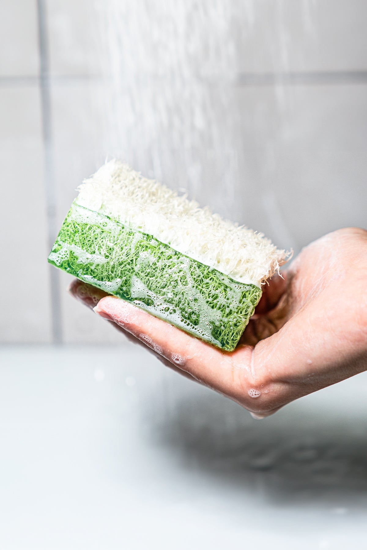 Green handmade exfoliating soap with organic loofah fiber top