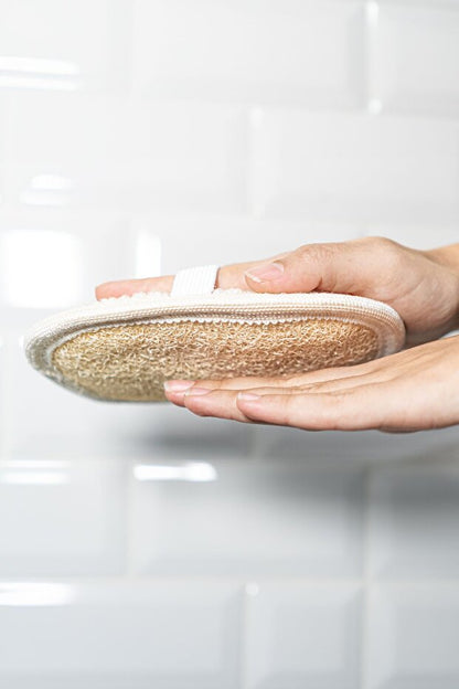 Hand holding a woven plate against a white background