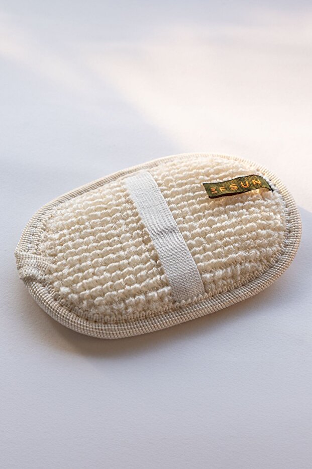 Beige exfoliating pad with a brand label on a white background